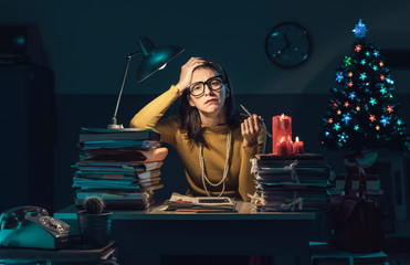 Frustrated businesswoman working on Christmas Eve