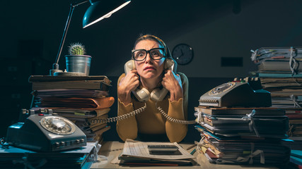 Frustrated secretary working overtime at night