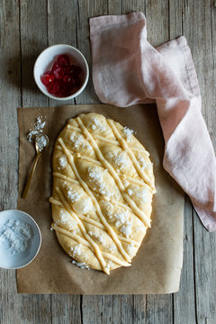 Top view of fresh Coca de San Juan pastry on timber table in rustic kitchen