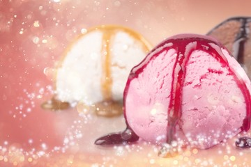 Scoops of ice cream with syrup on background