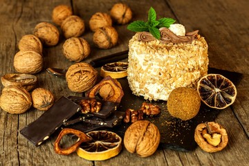 Sweet dessert. Walnut dessert. Tart on wooden table. Unhealthy food. Risk of diabetes. Walnuts.