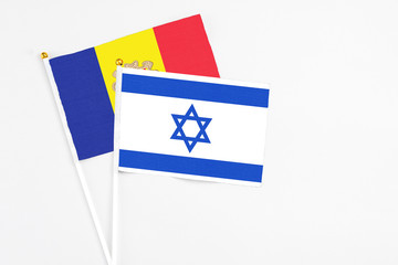 Israel and Andorra stick flags on white background. High quality fabric, miniature national flag. Peaceful global concept.White floor for copy space.
