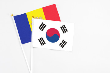 South Korea and Andorra stick flags on white background. High quality fabric, miniature national flag. Peaceful global concept.White floor for copy space.