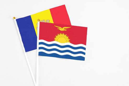 Kiribati and Andorra stick flags on white background. High quality fabric, miniature national flag. Peaceful global concept.White floor for copy space.