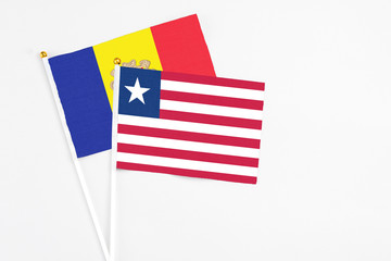 Liberia and Andorra stick flags on white background. High quality fabric, miniature national flag. Peaceful global concept.White floor for copy space.