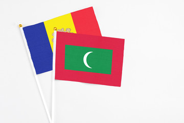 Maldives and Andorra stick flags on white background. High quality fabric, miniature national flag. Peaceful global concept.White floor for copy space.