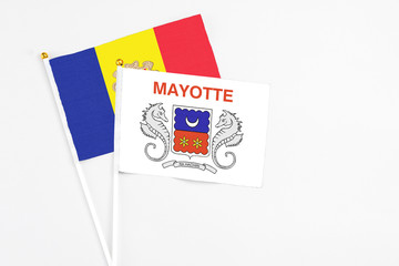 Mayotte and Andorra stick flags on white background. High quality fabric, miniature national flag. Peaceful global concept.White floor for copy space.