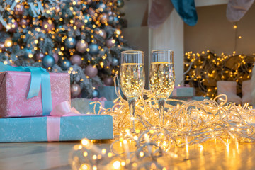 Fototapeta na wymiar Two glasse of champagne on a Christmas New year background and decoration, light bokeh effect