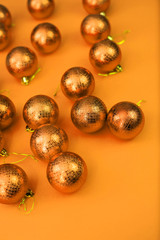 Orange Yellow Christmas baubles decoration on Orange Yellow background. New Year greeting card. Minimal style. Flat lay.