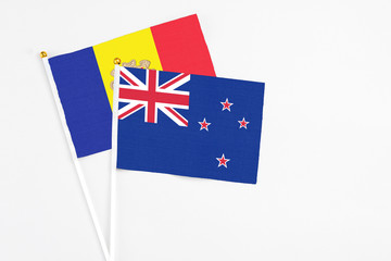 Fototapeta premium New Zealand and Andorra stick flags on white background. High quality fabric, miniature national flag. Peaceful global concept.White floor for copy space.