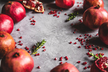 Pomegranate fruit. Ripe and juicy pomegranate on rustic grey background