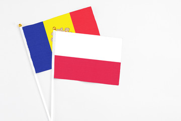 Poland and Andorra stick flags on white background. High quality fabric, miniature national flag. Peaceful global concept.White floor for copy space.