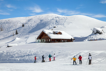 Skiers on mountain slope in Italian Dolomites
