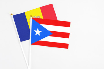 Puerto Rico and Andorra stick flags on white background. High quality fabric, miniature national flag. Peaceful global concept.White floor for copy space.