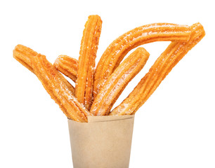 Churro stick in apaper bag.  Churro - Fried dough pastry with sugar powder isolated on a white background.  Close up