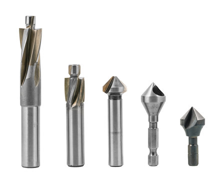 Set of counterbores and countersinks isolated on a white background. Steel cylindrical and conical fluted cutting tools for drilling countersunk or counterbored holes. Metal silvery machining cutters.