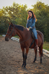 Beautiful young woman with horse outdoors