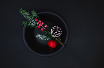 Obraz na płótnie Canvas Christmas decoration with branches of fir tree on dark background. Xmas tree, pine, winter festive Card. Top view. Copyspace
