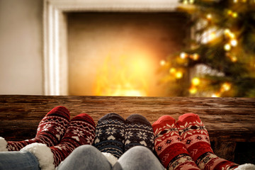 Woman legs with christms socks. Free space for your decoration. Xmas tree and fireplace. 