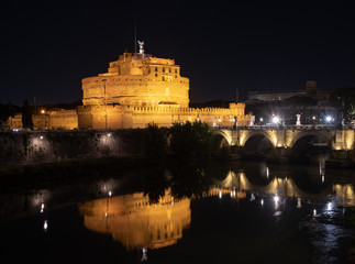 Saint Angel Castle and Bridge, Rome, Italy. Night, long exposure. Reflection in Tiber river. 