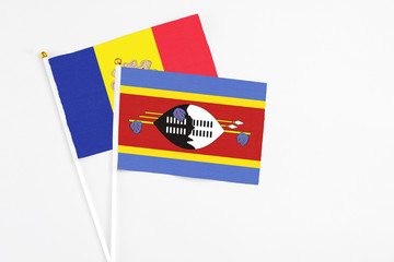 Swaziland and Andorra stick flags on white background. High quality fabric, miniature national flag. Peaceful global concept.White floor for copy space.