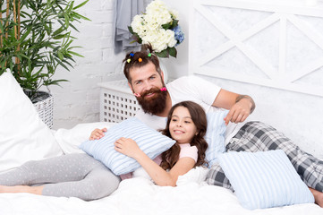 Obraz na płótnie Canvas small girl with bearded father in bed. weekend at home. father and daughter having fun. family bonding time. love my daddy. happy morning together. funny pajama party. Close friends. Friendly family