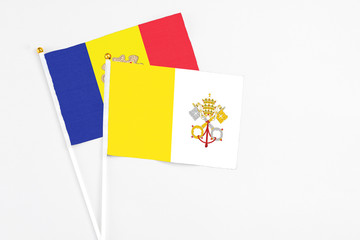 Vatican City and Andorra stick flags on white background. High quality fabric, miniature national flag. Peaceful global concept.White floor for copy space.