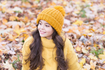 Beautiful hair with beautiful care. Happy girl wear hat on long brunette hair. Little child relax on autumn landscape. Autumn hair care routine. Caring of hair in fall