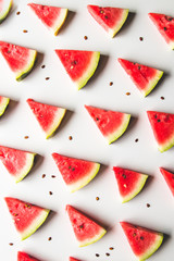 Seamless summer pattern. Watermelon slices, seeds on white background, top view