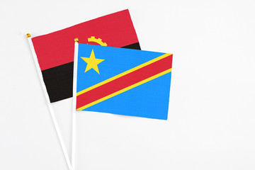 Congo and Angola stick flags on white background. High quality fabric, miniature national flag. Peaceful global concept.White floor for copy space.