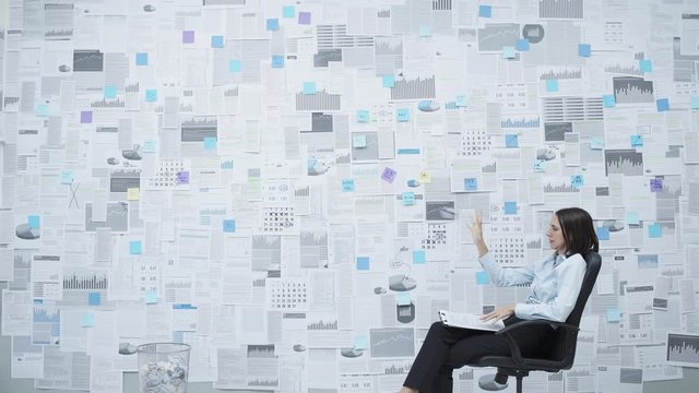 Frustrated businesswoman trashing paperwork