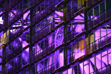 Purple light reflections in the glassy facade