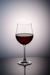 red wine in a wine glass on the background