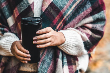 Woman hold cup in forest, autumn photograph