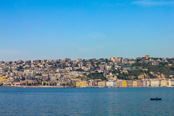 a lone fisherman rowing on the promenade of naples, campania, italy