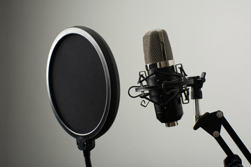 Microphone on stand with diffuser on a white background