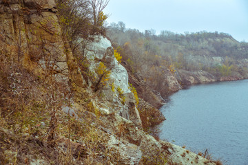 Rocky rock of the mountain over the lake 's posture