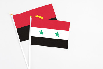 Syria and Angola stick flags on white background. High quality fabric, miniature national flag....