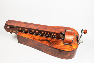 Hurdy gurdy musical instrument on white