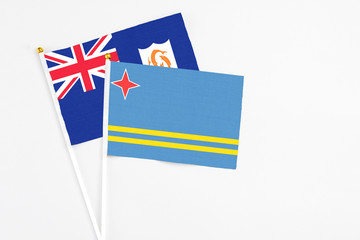 Aruba and Anguilla stick flags on white background. High quality fabric, miniature national flag. Peaceful global concept.White floor for copy space.