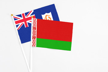 Belarus and Anguilla stick flags on white background. High quality fabric, miniature national flag. Peaceful global concept.White floor for copy space.