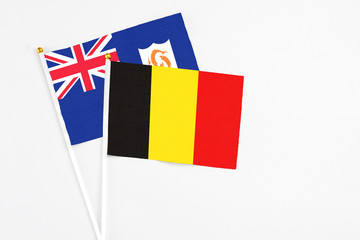 Belgium and Anguilla stick flags on white background. High quality fabric, miniature national flag. Peaceful global concept.White floor for copy space.