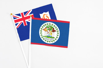 Fototapeta premium Belize and Anguilla stick flags on white background. High quality fabric, miniature national flag. Peaceful global concept.White floor for copy space.