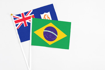 Brazil and Anguilla stick flags on white background. High quality fabric, miniature national flag. Peaceful global concept.White floor for copy space.