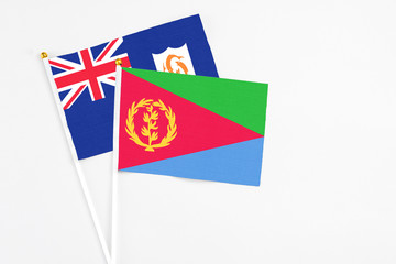 Eritrea and Anguilla stick flags on white background. High quality fabric, miniature national flag. Peaceful global concept.White floor for copy space.