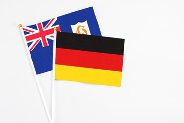 Germany and Anguilla stick flags on white background. High quality fabric, miniature national flag. Peaceful global concept.White floor for copy space.