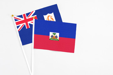 Haiti and Anguilla stick flags on white background. High quality fabric, miniature national flag. Peaceful global concept.White floor for copy space.
