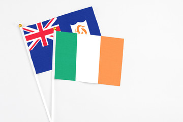 Ireland and Anguilla stick flags on white background. High quality fabric, miniature national flag. Peaceful global concept.White floor for copy space.