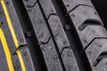 The tread of a new car tire. Car accessories.