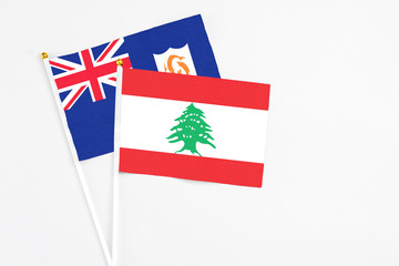 Lebanon and Anguilla stick flags on white background. High quality fabric, miniature national flag....